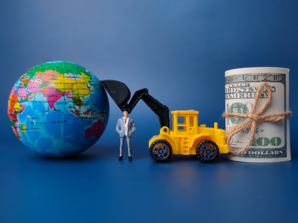 Global economic transformation with world globe, business figures and monetary symbols