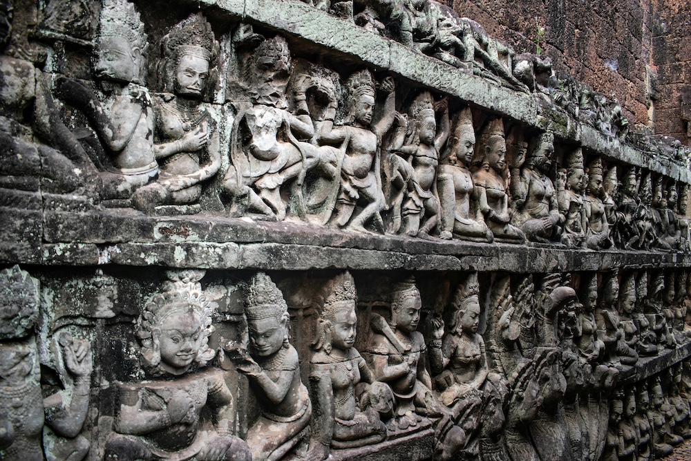 Angkor Wat silhouette reflected in water during sunset