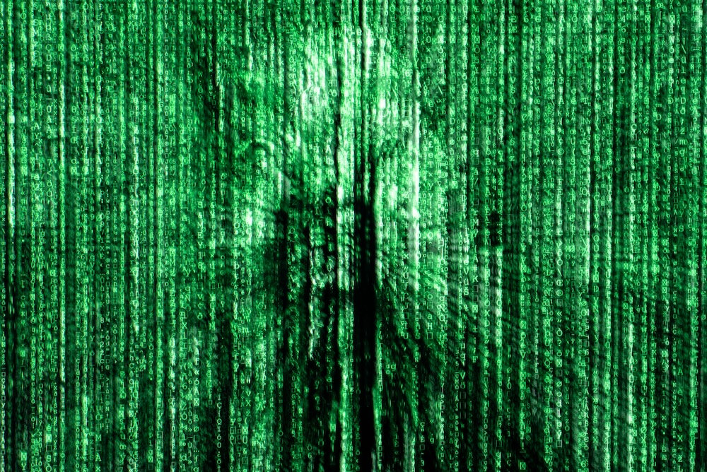 Human face dissolving into digital code